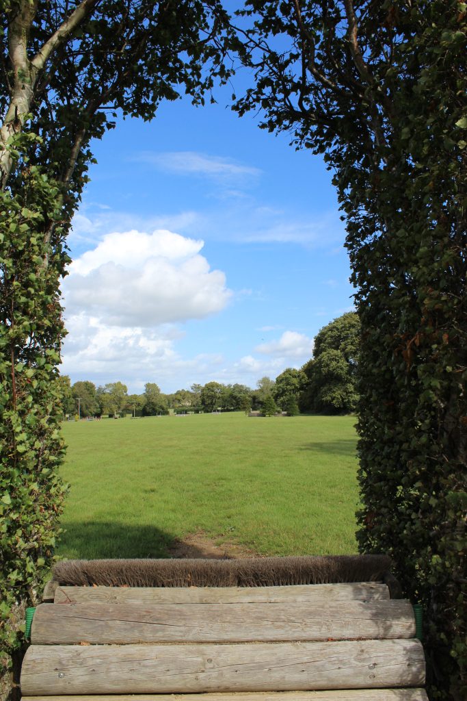 The view of Lodge Farm Cross Country Course through the iconic 'owl hole' jump.